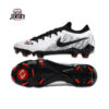 Brand: Nike Model: Mercurial Vapor 15 Elite FG Pack/Edition: Whiteprint Pack Colorway: Black / Red / White accents Ground Type: Firm Ground (FG) – for natural grass pitches Upper Material: Vaporposite+ (lightweight engineered mesh with Flyknit integration) Key Technologies: Air Zoom Unit – responsive cushioning and explosive acceleration Speed Cage System – provides lightweight stability during quick cuts ACC (All Conditions Control) – consistent ball control in both wet & dry conditions Outsole: Aerotrak 2 soleplate with angular studs for maximum traction & speed bursts Design Highlights: Sleek black base with sharp red detailing Clean white swoosh across lateral side Aggressive stud layout engineered for acceleration Fit: Adaptive snug fit, true-to-size Weight: Ultra-light for elite-level performance
